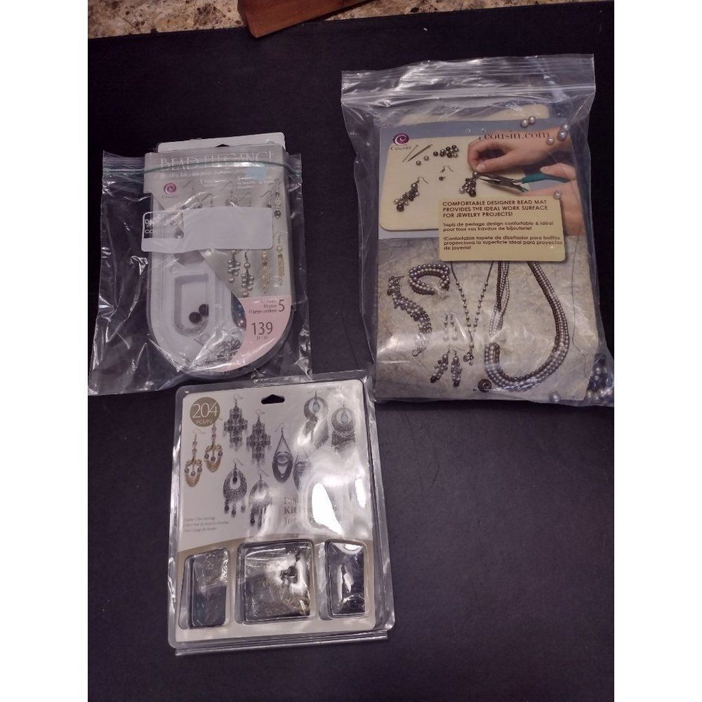Three opened jewelry making kits